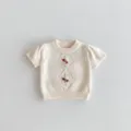 Detailed view of baby knit short-sleeve top, soft cotton fabric with delicate embroidery. - 66cm / Tops