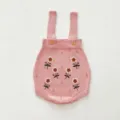 Close-up detail of infant baby pink knit romper featuring charming floral embroidery and buttons. - 66cm / Pink Romper