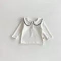 Baby white long sleeve top featuring a cute black scalloped collar and front button closure. - 73 / Tops