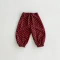 Detailed view of dark red baby cotton bloomers with cute white floral print and elastic cuffs. - 73cm / Bottoms / Wine Red Pants
