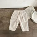Infant beige corduroy long pants, minimalist retro baby trousers with elastic waist. - 66cm / Pants / Off White