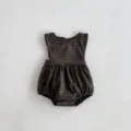 Close-up detail of dark plaid baby romper, soft infant sleeveless clothing with snap closure. - 66cm / Coffee Plaid Romper