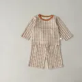Detailed view of baby checkered long sleeve top and shorts set in brown and white gingham. - 66cm / Light Khaki