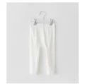 Detail shot of white cotton baby leggings, soft fabric and comfortable fit for infant wear. - 66cm / White