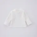 Detailed view of the white ribbed baby long sleeve top, soft fabric and classic crew neck. - 66cm / Tops