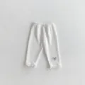 Infant baby white ribbed leggings with black bow embroidery and lace hem, soft comfortable pants. - Off White