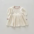 Detailed view of baby girl knit dress, diamond hollow pattern and cute puff sleeves. - 110cm / Off White