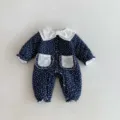 Detailed view of cute baby winter quilted jumpsuit, dark blue polka dot fabric, lace collar. - 66cm / Dark Blue