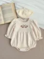 Detailed view of baby girl waffle knit romper with floral embroidery and matching beret hat. - 66 / Apricot