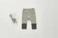 Baby striped leggings detail showing soft cotton fabric and ribbed cuffs in a neat flat lay. - Dark Gray White Stripe