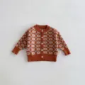 Infant knitted cardigan close-up, caramel color with geometric pattern and white buttons, cozy fabric detail. - 66cm / Brown Blazer