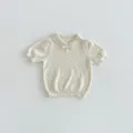 Detail view of a Korean-style baby knit short-sleeve top with a sweet polo collar and bow. - 73cm / Tops / Apricot