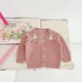Pink baby girl knit cardigan with floral embroidery and white buttons, cozy infant sweater detail. - 73 / Tops