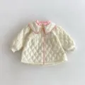 Toddler girl quilted jacket detail view featuring elegant pink ruffled collar and diamond pattern. - 90cm / Beige