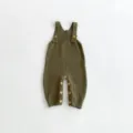 Close-up detail of olive green baby knit romper, waffle texture, natural wood buttons. - 66cm / Jumpsuits / Army Green