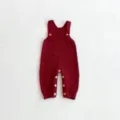 Knitted baby romper jumpsuit detail view showcasing soft texture and cute wooden buttons. - Red