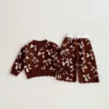 Close-up detail of toddler girls knit sweater and pants set with cute white bows design. - 73cm / Set / Brown