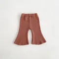 Detail shot of baby knitted flare pants featuring a ribbed texture and comfortable elastic waist. - 66cm / Brown