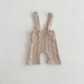 Detailed view of baby cable knit suspender shorts, soft cotton material texture and cute buttons. - 66cm / Bottoms