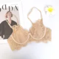Detailed view of women's beige lace bra, featuring delicate floral pattern and adjustable straps. - 70B / Tops / Nude