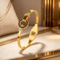 Gold titanium steel bracelet with red green enamel and rhinestones fashion jewelry. - Gold
