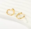 Close-up detail of golden irregular curved open hoop earrings, showcasing the chic shiny texture. - Irregular Open Streamline Studs