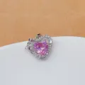 Detailed close-up of sparkling pink heart cubic zirconia pendant with crystal bow design. - Gold Light Pink Heart