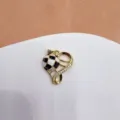 Close-up detail of heart hollow football pendant with micro-inlaid zircon and black-white oil drop. - Heart Hollow Soccer (Enamel)