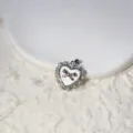 Close-up view of heart-shaped pendant with sparkling micro-inlaid cubic zirconia and bow detail. - Heart Bowknot Shape