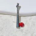 Close-up view of a silver baseball bat and red ball pendant, detailed metal craft charm. - Silver and Red Ball Style