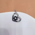Silver-tone heart-shaped hollow soccer pendant with cubic zirconia and black enamel detail. - Heart Hollow Soccer (Silver)