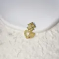 Close-up detail of a gold-plated pave cubic zirconia bow and dual heart pendant accessory. - Bow Double Heart (3)