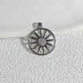 Round gold plated pendant with sun wheel design and micro pave cubic zirconia detail. - Silver