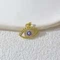 Eleganter vergoldeter Böser-Blick-Anhänger mit funkelnden Zirkonia-Details, schöne Detailaufnahme. - Gold Böser Blick (1)
