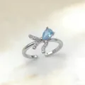 Eleganter offener Ring mit funkelndem tropfenförmigen blauen Stein und feinen Zirkonia-Schleifen. - Schleife Wassertropfen Hellblauer Zirkonia (1) / Gold