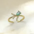 Vergoldeter offener Ring mit birnenförmigem Zirkon und funkelnden Steinen im schicken Design. - Schleife Wassertropfen Grünblauer Zirkonia (5)