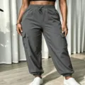 Detail shot of dark grey cargo pants with multi pockets, high waist and elastic cuffs. - S / Bottoms / Dark Gray