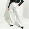 White high-waisted wide-leg trousers detail shot, premium drape fabric and tailored fit. - White