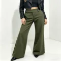 Close-up view showing the high waist design, draping fabric, and wide-leg cut of the trousers. - Army Green