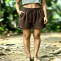 Detail view of women's waffle knit casual shorts with elastic drawstring waist and pockets. - Coffee