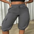 Grey cargo capris detail shot showing side pockets, elastic drawstring waist and cuffed hems. - S / Bottoms / Dark Gray