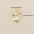 Detail shot of the gold-plated crescent moon pendant with sparkling cubic zirconia stones. - Gold