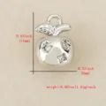 Close up of a metallic apple pendant featuring sparkling cubic zirconia star details, small size. - Silver