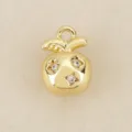 Gold plated apple pendant detail, star shaped zirconia inlay, DIY jewelry accessory close up - Gold