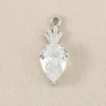 Detailed shot of a silver-toned carrot pendant featuring a sparkling clear cubic zirconia stone. - Silver