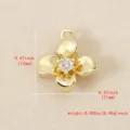 Close-up detail of 18k gold plated brass four-petal flower pendant with sparkling cubic zirconia. - Gold