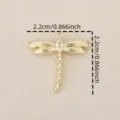 Close-up detail of a gold plated dragonfly pendant with sparkling cubic zirconia stone. - Gold