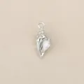 Close-up detail of a silver-toned conch shell pendant inlaid with sparkling cubic zirconia. - Silver