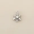 Close up view of the silver tone snowflake charm pendant showing intricate details and loop. - Silver