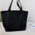 Black canvas lunch bag for office workers, durable bento tote bag with double handles. - Black